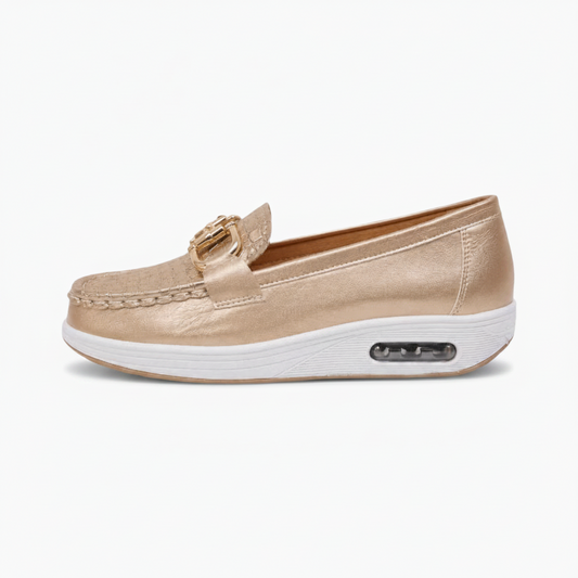Détail du mors et de la chaîne dorés sur le mocassin, apportant une touche de brillance distinctive.