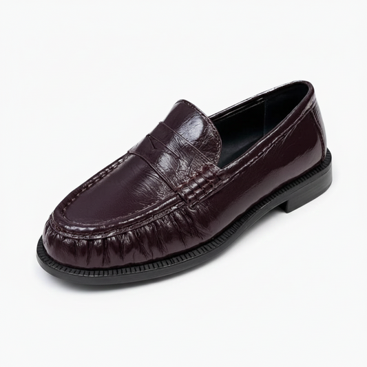 Mocassin femme en cuir bordeaux riche, présentant une finition élégante et une silhouette classique.