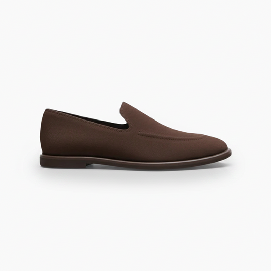 Vue plongeante sur une paire de mocassins en daim marron foncé, soulignant la coupe classique et la finition veloutée.