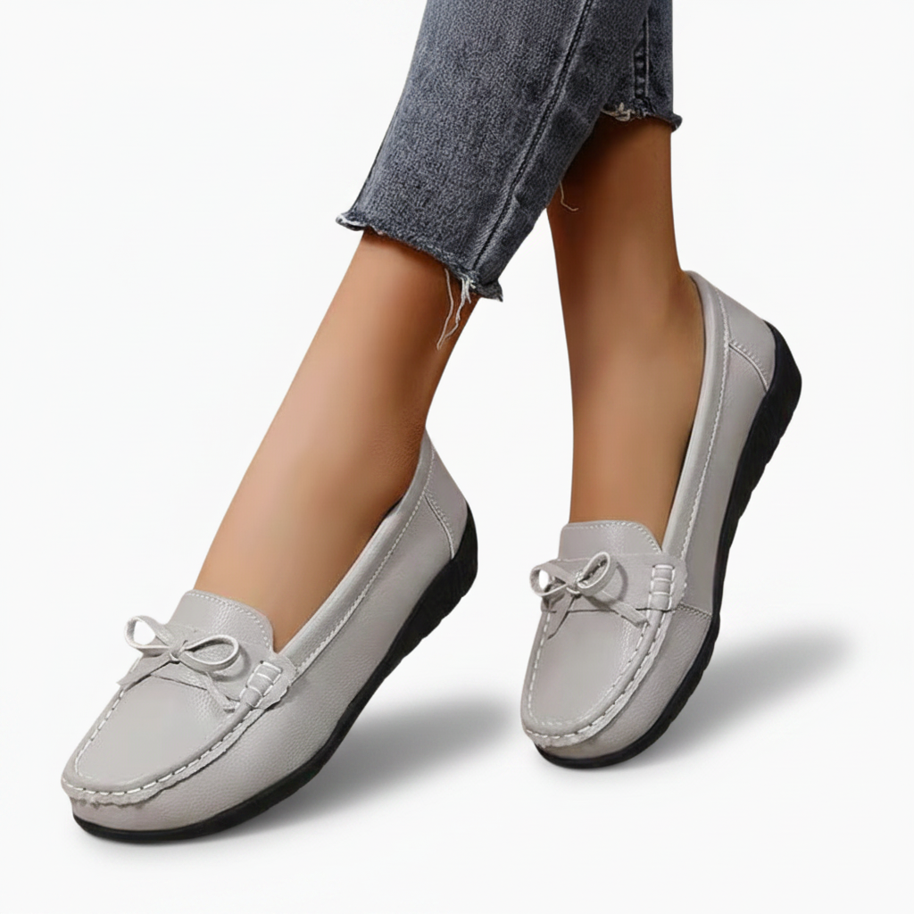 Détail de la semelle intérieure rembourrée et de la semelle extérieure antidérapante du mocassin en cuir gris.